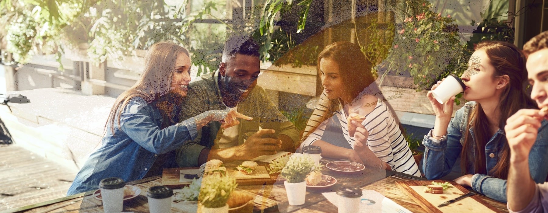 lifestyle image of people laughing outdoors at a table
