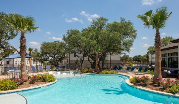 pool area showing reclining seating, wooden coverings and ample space