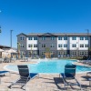 Westover Hills apartment pool with young small palm trees and tropical landscaping