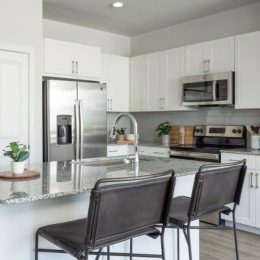 kitchen with ample counter-space, modern appliances and bright lighting